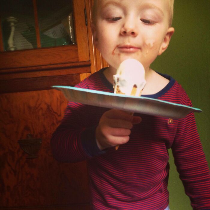 Child using a plate to catch ice cream drips, showcasing parenting genius tricks.