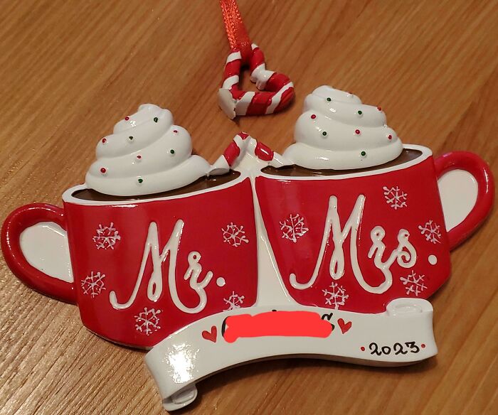 "Christmas ornament of broken mugs labeled Mr. and Mrs., symbolizing holiday accidents."