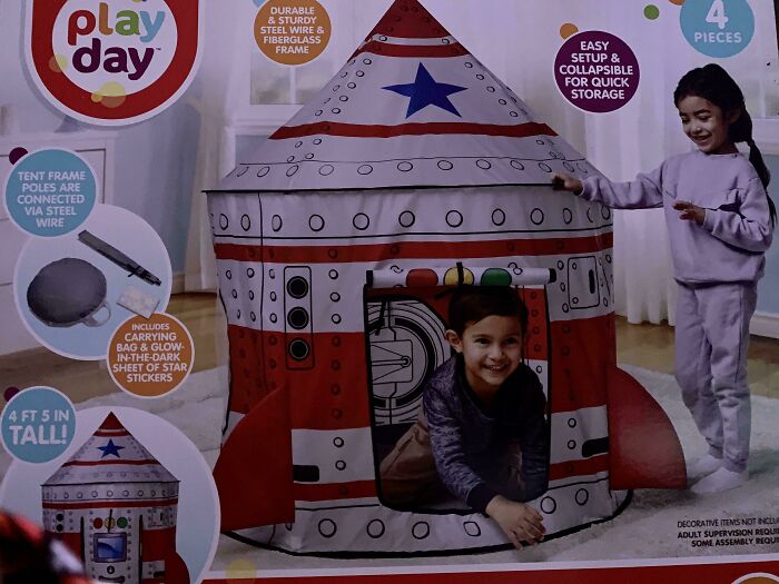 Children playing happily in a rocket-shaped play tent, a potential spot for Christmas accidents.