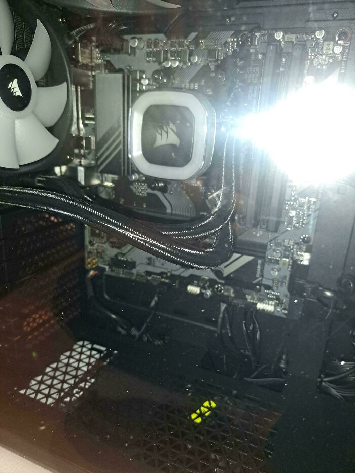 Christmas accident: Computer interior with apparent damage, wires exposed, and a visible reflection inside a PC case.