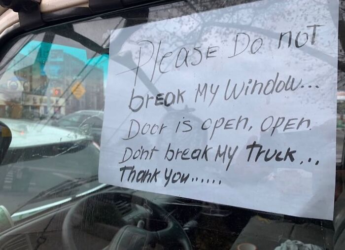 Sign on car window in New York: "Please do not break my window. Door is open. Don't break my truck. Thank you."