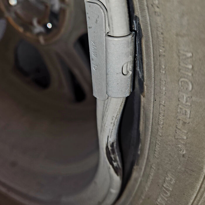 Close-up of a damaged tire with a metal clamp, illustrating Christmas accident hazards.