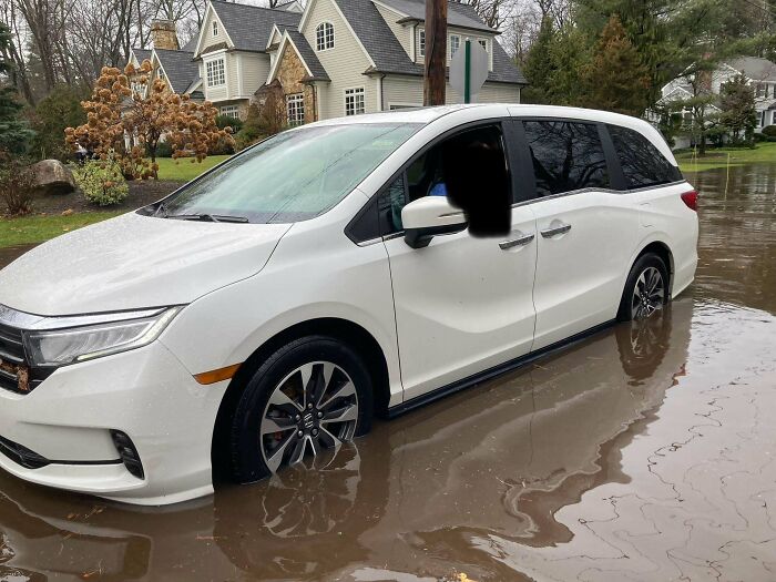 White van stuck in flooded suburban street, illustrating Christmas accident.