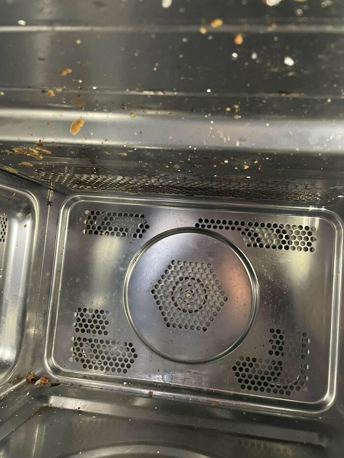 Dirty microwave interior after a Christmas cooking accident, with splatters on the walls.