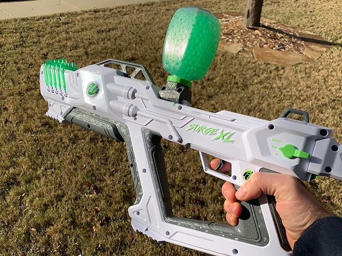 Teen gift idea: person holding a Surge XL paintball gun outdoors.