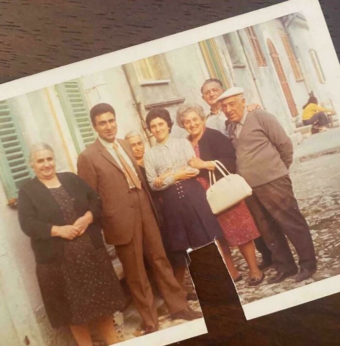 Group of people in 60s fashion looks, outdoors in vintage attire, featuring retro dresses and suits.