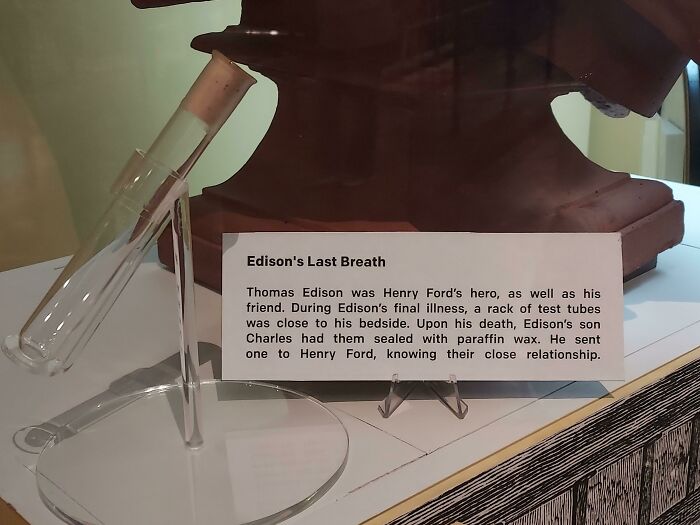 Test tube labeled "Edison's Last Breath" displayed at a museum exhibit with historical information.