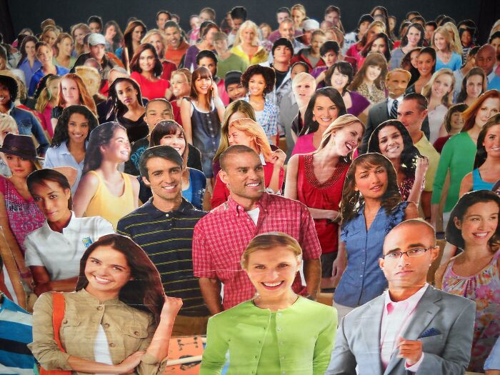 A crowd of diverse cardboard cutouts of people, showcasing fascinating details and vibrant expressions.