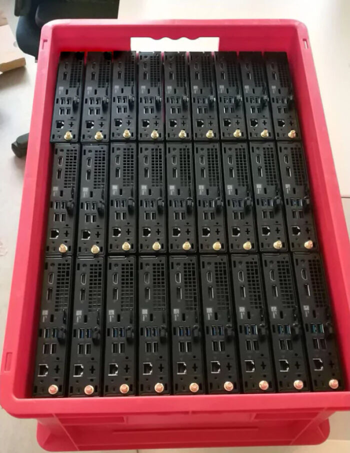 Neatly arranged electronic devices in a red crate, illustrating a satisfying perfect fit.