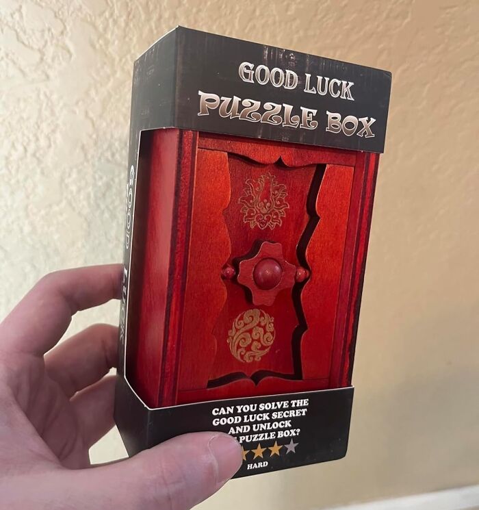 Hand holding a Good Luck puzzle box, a creative way to gift a gift card.