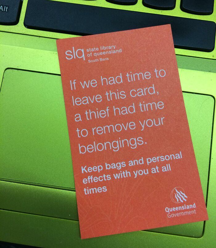 A cautionary card on a laptop, advising to keep belongings safe, from State Library of Queensland.