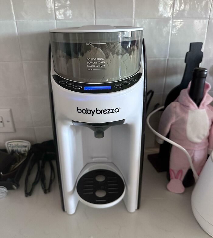 Baby formula maker on kitchen counter, a parenting genius trick for easy bottle preparation.