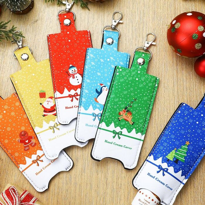 Colorful Christmas-themed hand cream covers, with festive designs on a wooden table, related to viral "Brr Basket" video.