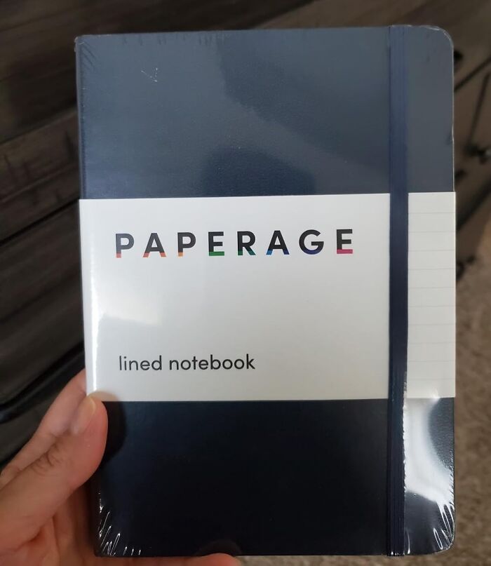 Person holding a Paperage lined notebook.