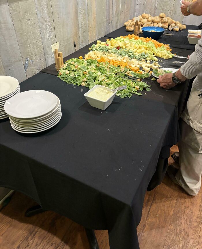 Buffet table with salad and fruits scattered, a Christmas accident waiting to happen.