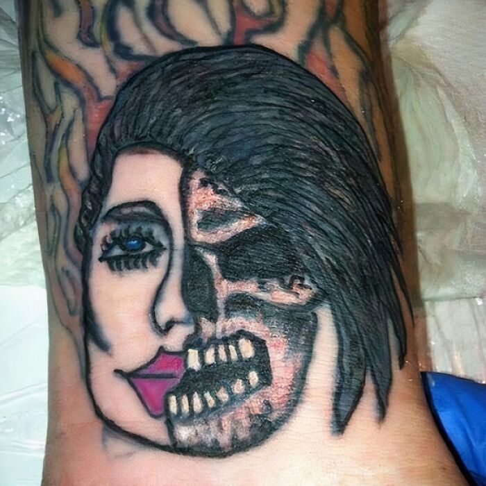 Epic tattoo fail featuring a half-face design split between a woman and a skull on skin.