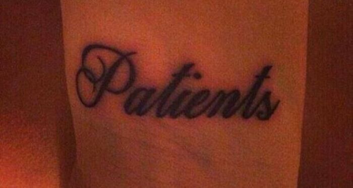 Epic tattoo fail with the word "Patients" misspelled on skin in cursive font.