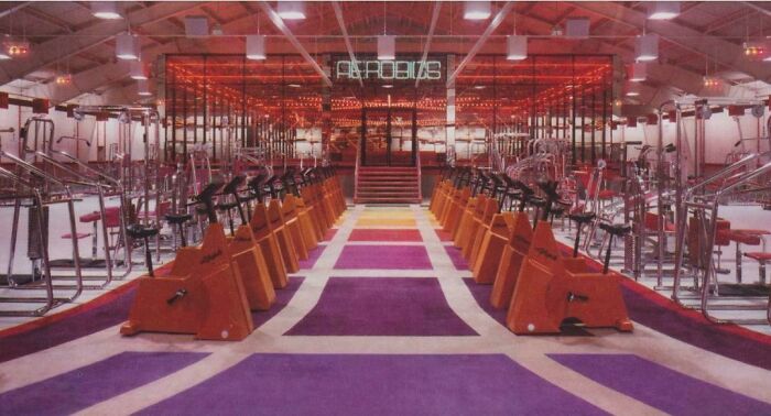 80s gym fitness center with vibrant decor and vintage workout equipment rows.