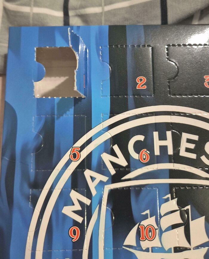 Advent calendar with Manchester City logo showing two numbers 5, 6, highlighting a Christmas accident with missing chocolate.