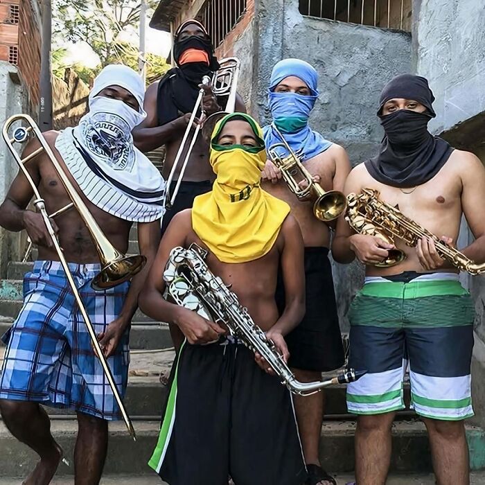 Group of masked individuals holding brass instruments, creating a cursed image vibe.