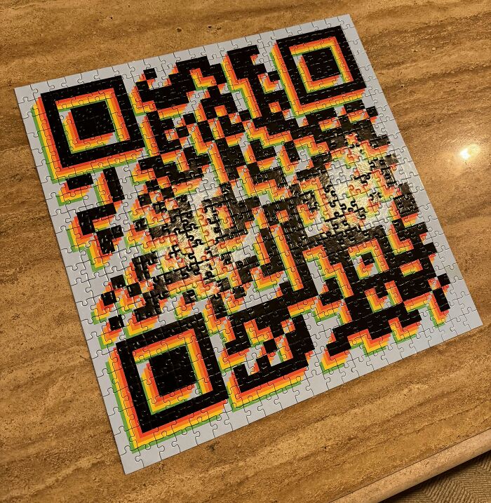 A QR code puzzle assembled on a wooden table, possibly linked to Christmas accidents or a bad day theme.