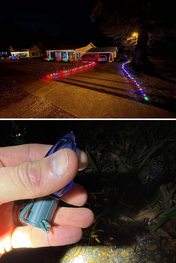 Broken Christmas light bulb after an accident on a festive driveway with colorful decorations.