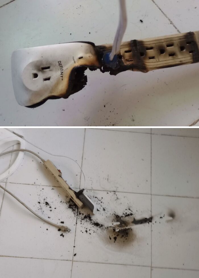 Burned power strip on a white floor, showcasing a Christmas accident.