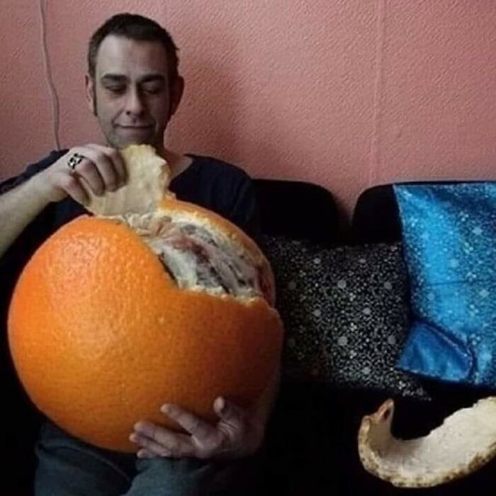 Man peeling giant orange, an unsettling cursed image popular on IG page.