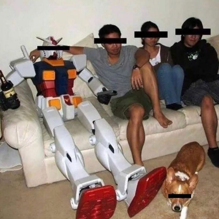 Cursed image featuring a Gundam robot sitting with people on a couch and a dog nearby.