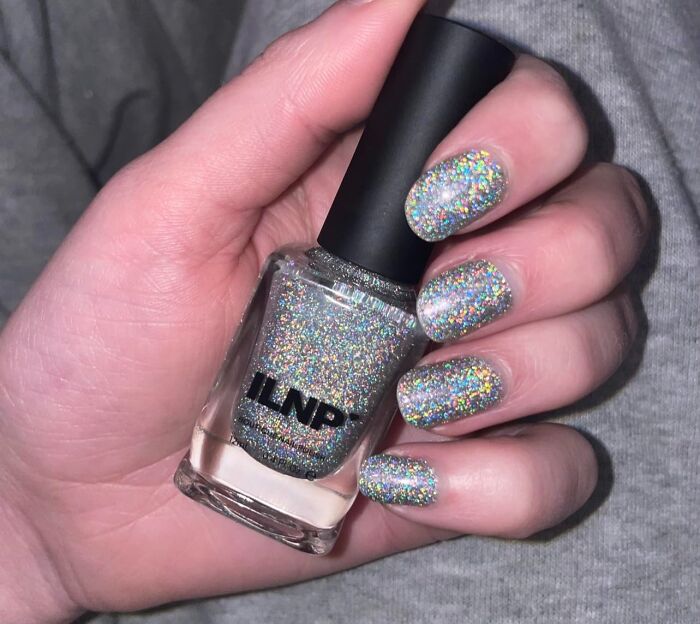 Sparkly nail polish gift idea with Amazon Prime, featuring holographic glitter nails holding a polish bottle.