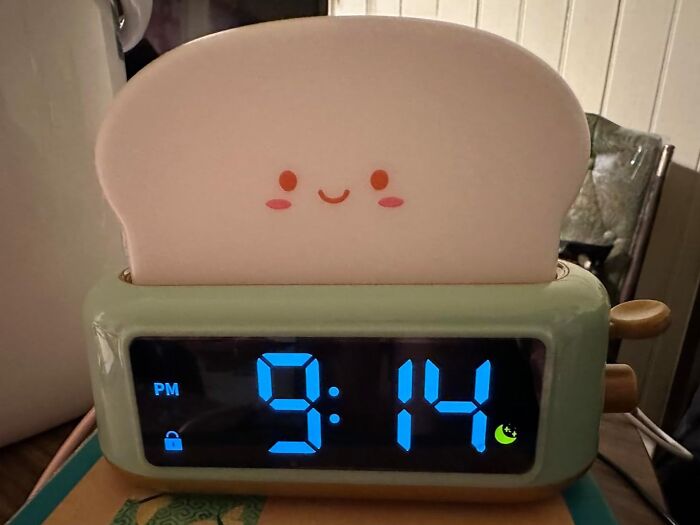 Cute toast-shaped clock displaying 9:14 PM with a smiling face, a random thing you might love or hate.