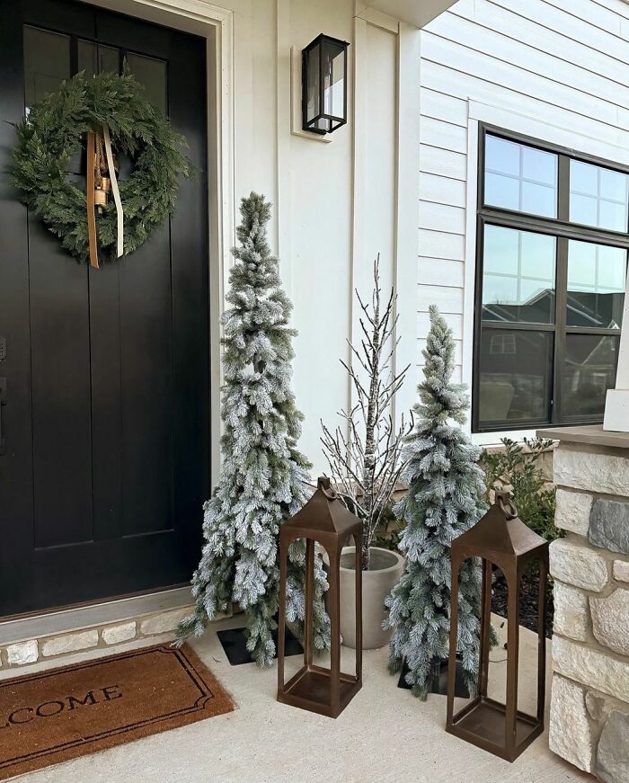 Frosted trees and wreath at entrance, highlighting Christmas decorating ideas.