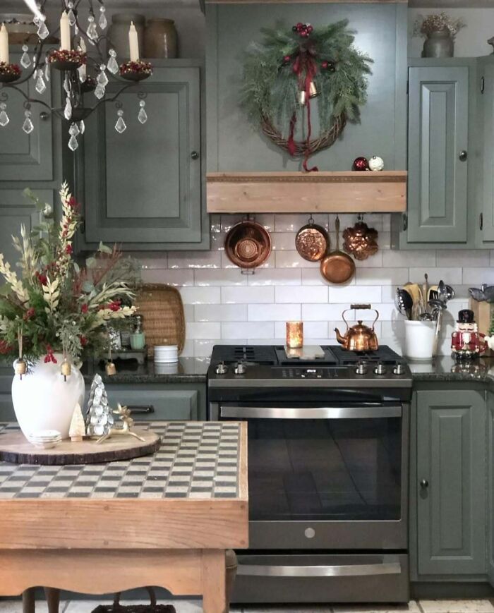 Festive kitchen with Christmas decorating ideas featuring a wreath, pine centerpiece, and holiday decor accents.