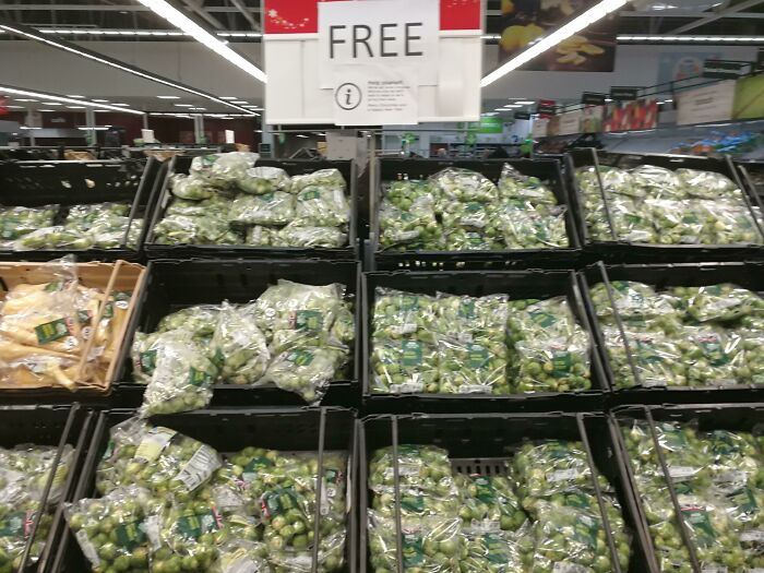 Free bags of Brussels sprouts in a store display, highlighting a wholesome Christmas theme.