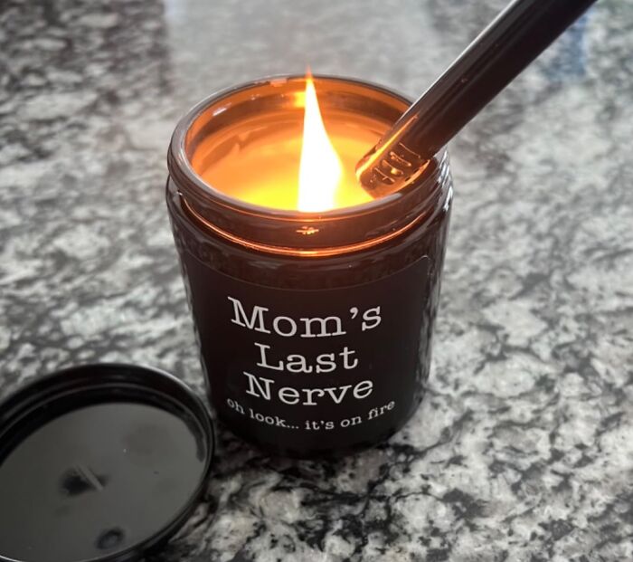 Candle labeled "Mom's Last Nerve" lit on a marble countertop, perfect special Christmas gift for mom.