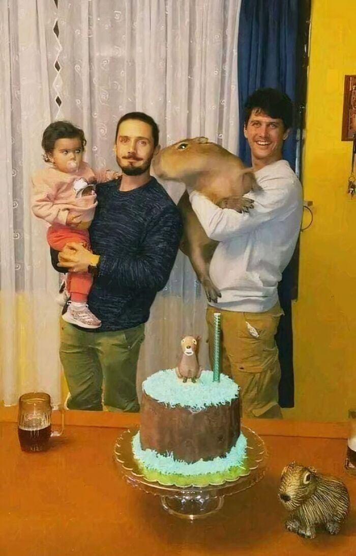 Family with child and capybara celebrating with a cake; a truly blessed image capturing joy and togetherness.