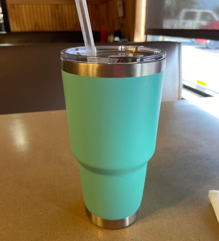 Turquoise insulated tumbler on a table, ideal for last minute budget gifts.