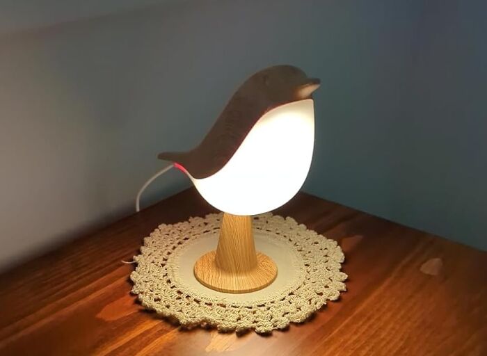 Bird-shaped lamp on a wooden table, ideal for last minute budget gifts.