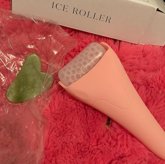 Peach ice roller and green facial tool on red surface, ideal for last minute budget gifts.