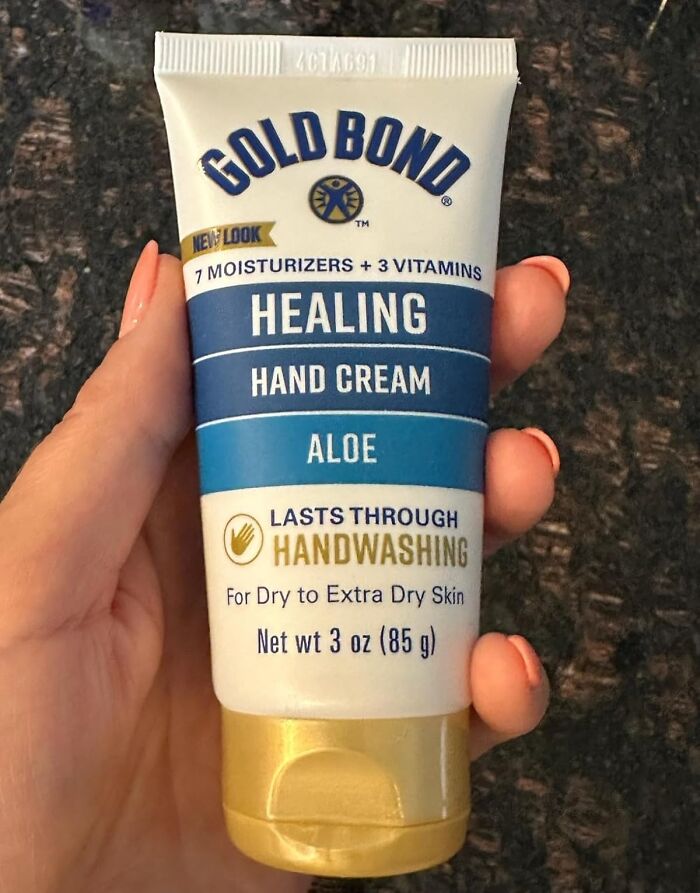 Hand holding Gold Bond Healing Hand Cream, a last minute budget gift option.