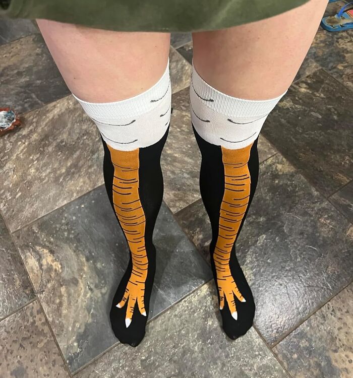 Silly white elephant gift idea with carrot-themed socks on a tiled floor.