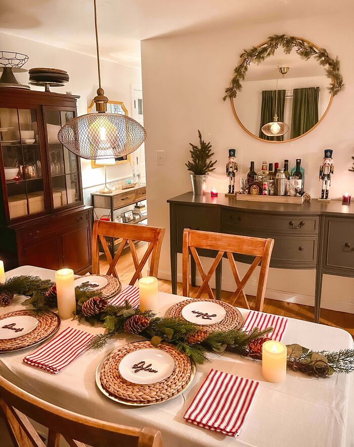 Festive dining room with pinecone centerpiece and candles, showcasing Christmas decorating ideas.