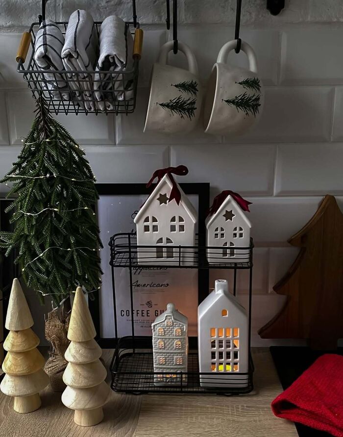 Miniature Christmas tree and decorative houses on a kitchen counter, showcasing festive Christmas decorating ideas.