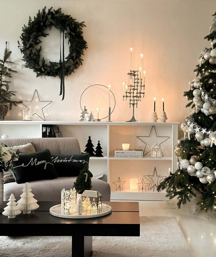 Cozy Christmas-decorating-ideas with a tree, wreath, candles, and star accents in a warm living room setting.