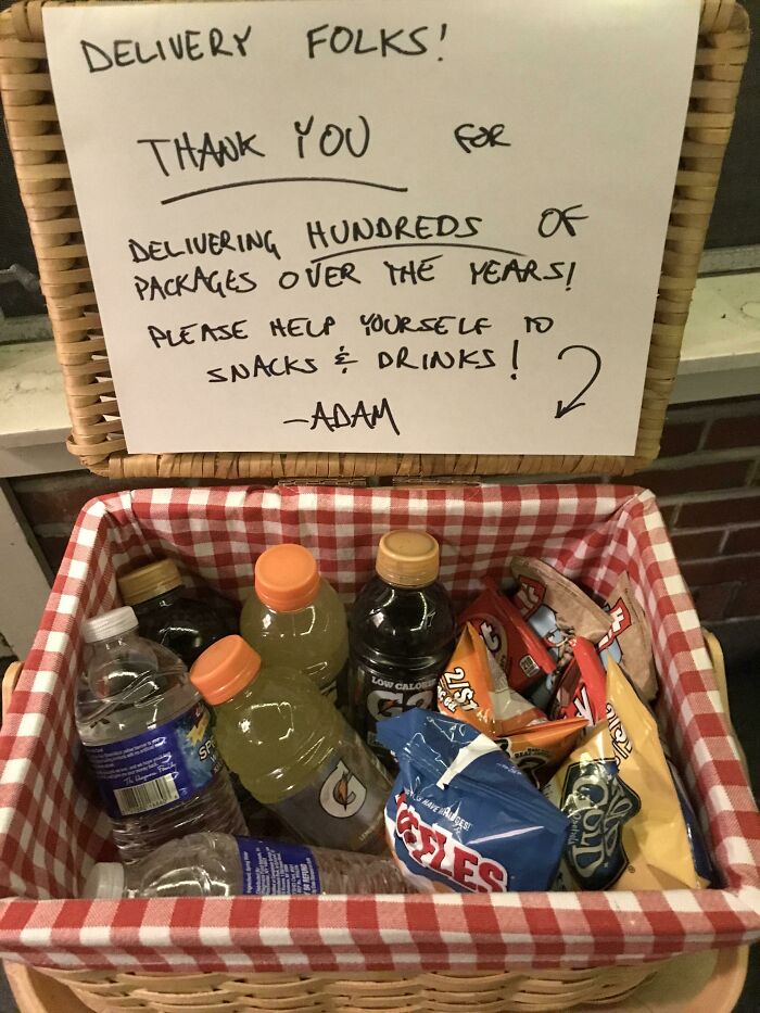 Basket offering snacks and drinks with a thank-you note for delivery folks, highlighting a wholesome Christmas gesture.