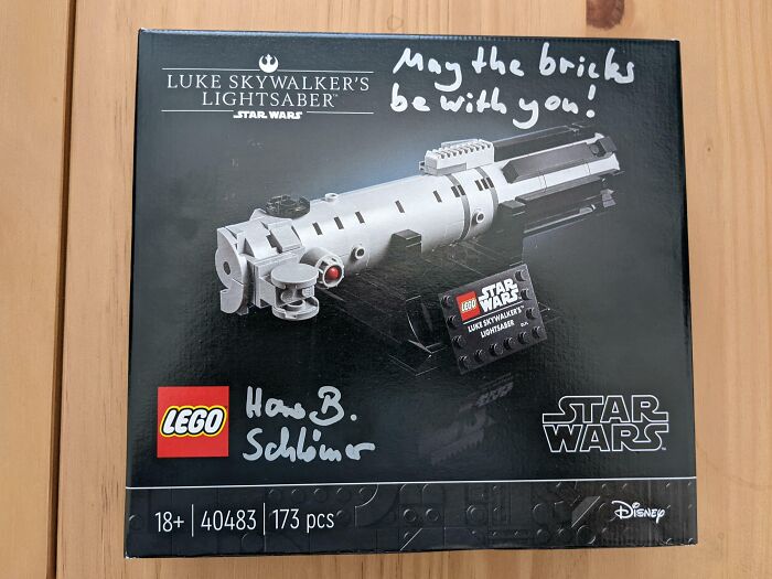 LEGO Luke's lightsaber box with handwritten "May the bricks be with you," adding a wholesome Christmas touch.