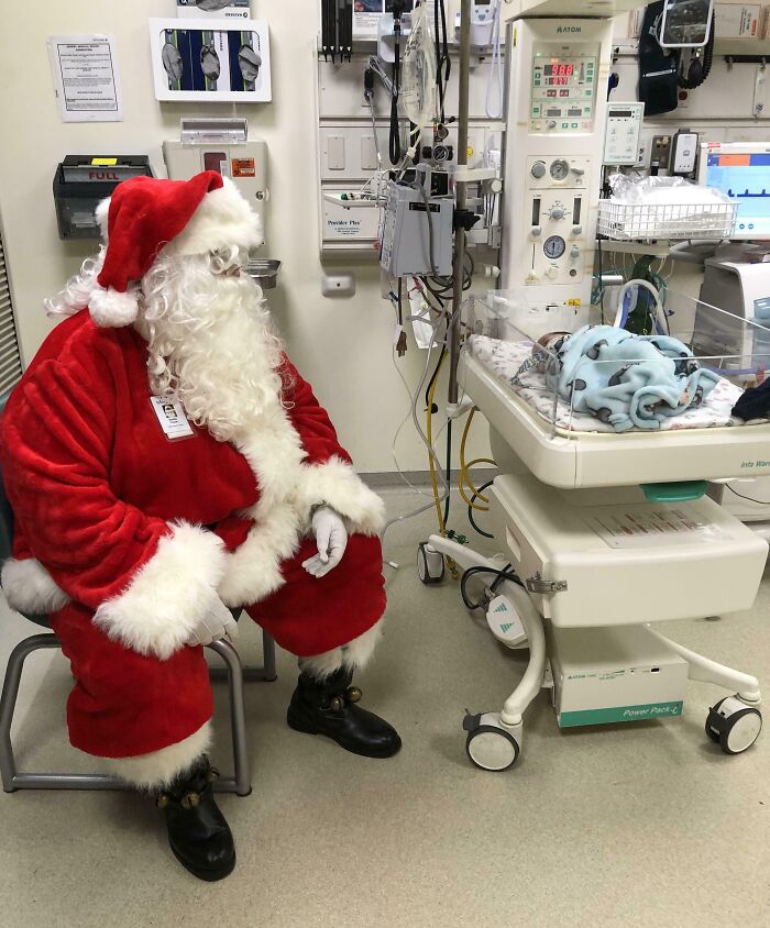 Santa visiting a baby in a hospital brings joy, highlighting a wholesome Christmas moment.