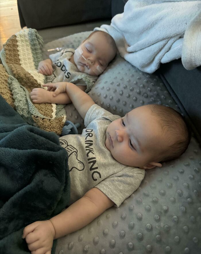 Two peacefully sleeping babies wrapped in cozy blankets for a wholesome Christmas moment.