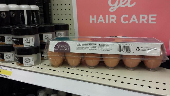 Carton of eggs placed on a shelf in the hair care aisle, exemplifying lazy-infuriating behavior.