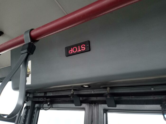 Upside-down "STOP" sign inside a vehicle, illustrating lazy infuriating people.